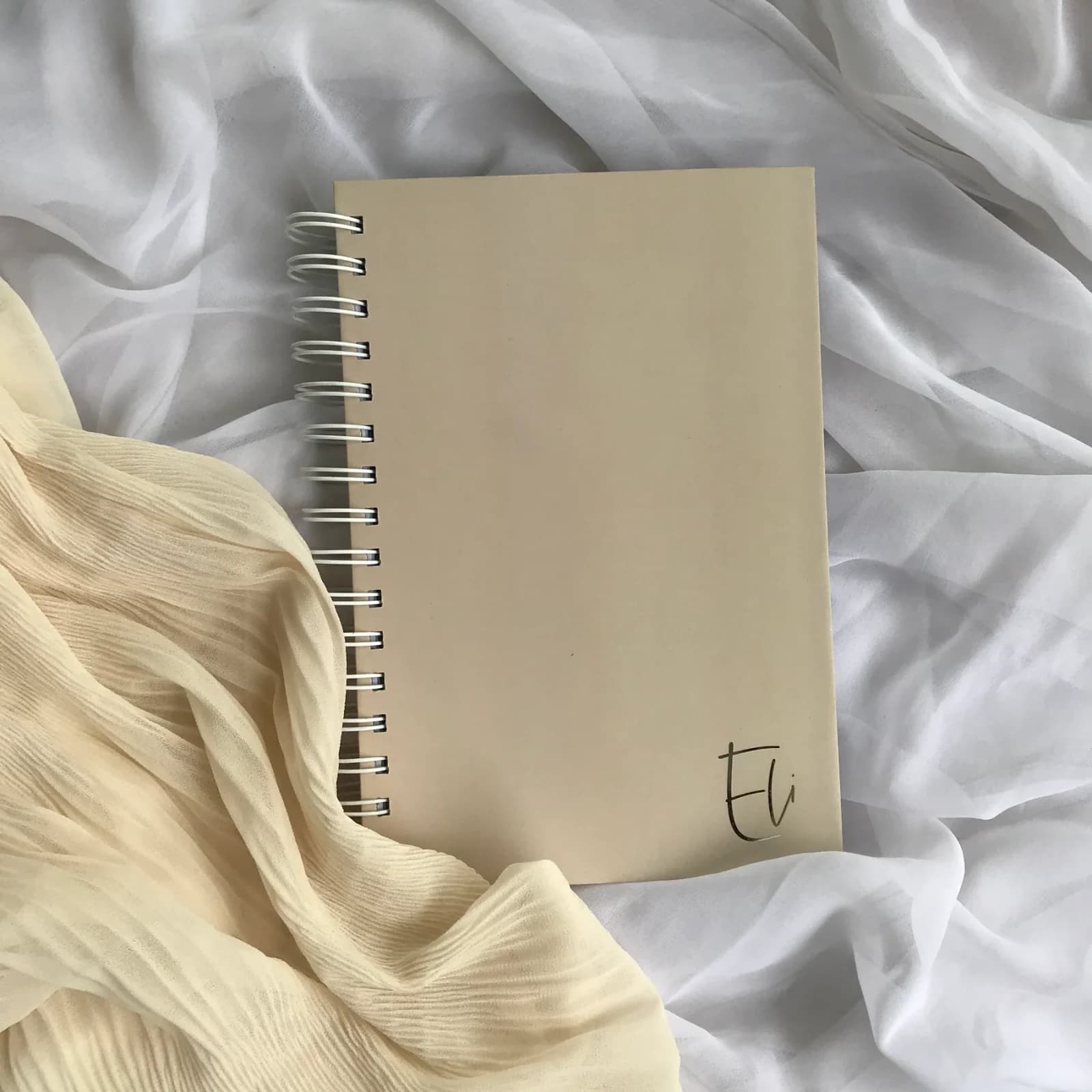 Blank Paper Notebook photographed on softly styled fabric